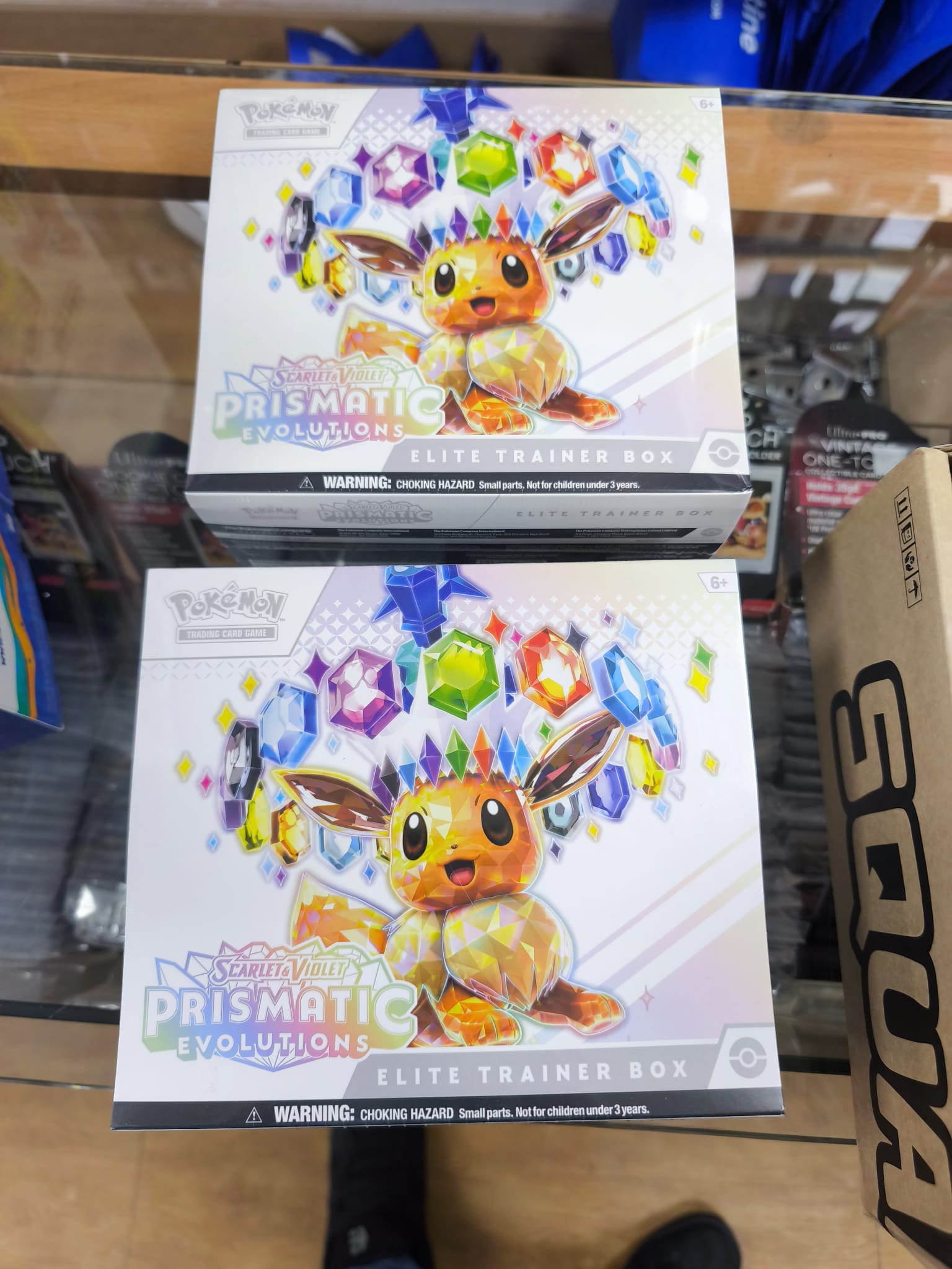 Caja Cromos Pokémon Prismatic Evolutions ETB Ingles